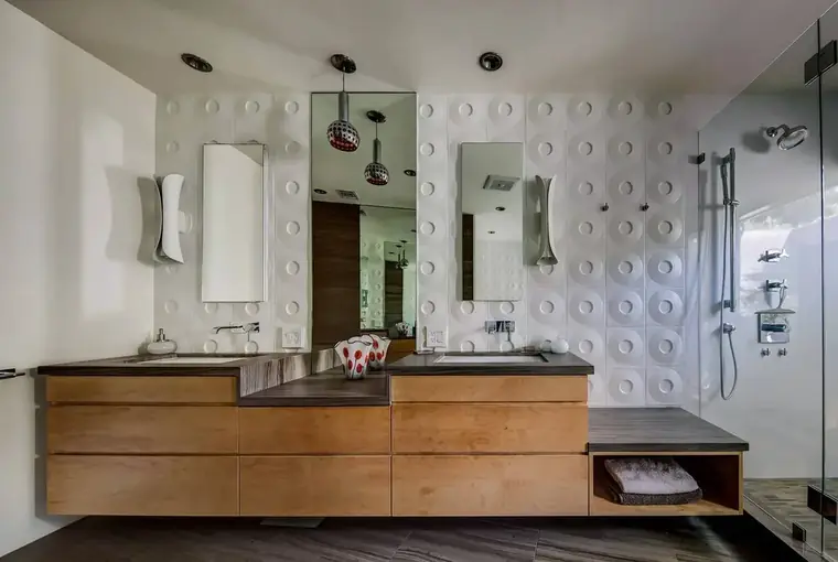 Bathroom with floating wood vanity and sculpted tile walls