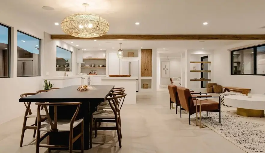 Open dining and living room under a beamed ceiling