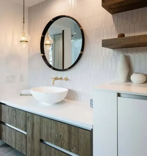 Vessel sink vanity with a round mirror and white tile