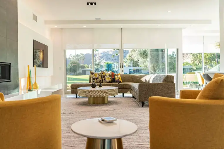 Living room opening to the garden through glass walls