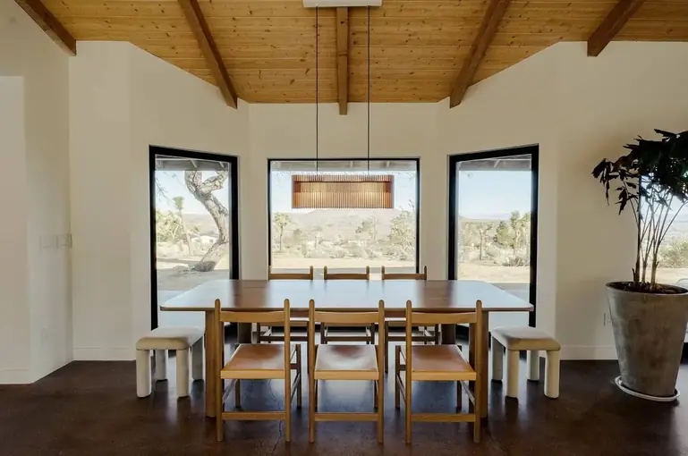 Dining room with a wood beam ceiling and desert views